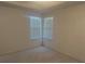 Well-lit bedroom featuring corner windows and carpet at 10819 Sw 84Th Ter, Ocala, FL 34481