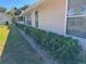 Exterior side view of home with mature landscaping and a neatly manicured lawn at 10819 Sw 84Th Ter, Ocala, FL 34481