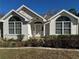 Charming front exterior with arched windows, stucco accents and mature landscaping at 10819 Sw 84Th Ter, Ocala, FL 34481