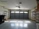 Spacious two car garage featuring plenty of shelving storage at 10819 Sw 84Th Ter, Ocala, FL 34481