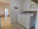 Laundry room with appliances and wood look tile at 10819 Sw 84Th Ter, Ocala, FL 34481