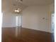 Living room with hardwood floors and a ceiling fan at 10819 Sw 84Th Ter, Ocala, FL 34481