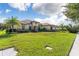 Beautiful single Gathering home featuring lush landscaping and well-manicured lawn at 31771 Red Tail Blvd, Sorrento, FL 32776