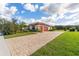 Beautiful single Gathering home boasting lush landscaping and a brick driveway at 31771 Red Tail Blvd, Sorrento, FL 32776