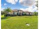 Beautiful one-story home showcasing meticulous landscaping, modern architectural details, and a vibrant green lawn at 31771 Red Tail Blvd, Sorrento, FL 32776