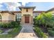 Beautiful home exterior with stone accents and lush landscaping at 31771 Red Tail Blvd, Sorrento, FL 32776