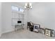 Bright living room featuring neutral tile flooring, modern lighting, and large windows with privacy blinds at 31771 Red Tail Blvd, Sorrento, FL 32776