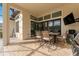 Inviting covered patio with a dining table, grill, and serene views of the yard with sliding glass doors at 31771 Red Tail Blvd, Sorrento, FL 32776