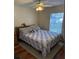 Bedroom with hardwood floors, a bed, and a ceiling fan at 35 Hemlock Terrace Dr, Ocala, FL 34472