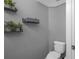 Small bathroom with toilet and shelving at 3921 Sw 51St Ter, Ocala, FL 34474