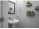 Clean, modern half bathroom with pedestal sink and stylish wall decor at 3921 Sw 51St Ter, Ocala, FL 34474