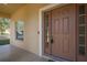 Front entry with brown door and sidelights at 3921 Sw 51St Ter, Ocala, FL 34474