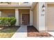 Front entry with brown door and walkway at 3921 Sw 51St Ter, Ocala, FL 34474