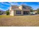 Two-story house with a screened porch and grassy backyard at 3921 Sw 51St Ter, Ocala, FL 34474