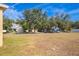 Large backyard with a view of neighboring houses and street at 3921 Sw 51St Ter, Ocala, FL 34474