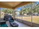 Relaxing screened porch with patio furniture and backyard view at 3921 Sw 51St Ter, Ocala, FL 34474