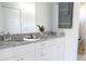 Double vanity bathroom with granite countertop and white cabinets at 6821 Se 103Rd St, Belleview, FL 34420