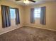 Spacious bedroom with neutral carpeting and large windows at 711 Ne 43Rd St, Ocala, FL 34479