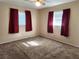 Spacious bedroom with neutral carpeting and ample natural light at 711 Ne 43Rd St, Ocala, FL 34479