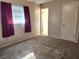 Well-lit bedroom with neutral carpeting and built-in closet at 711 Ne 43Rd St, Ocala, FL 34479