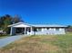 Cute ranch home with carport and well-maintained lawn at 711 Ne 43Rd St, Ocala, FL 34479