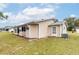 Tan house with screened porch and yard at 8475 Sw 109Th Lane Rd, Ocala, FL 34481