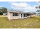 Tan house with screened porch and yard at 8475 Sw 109Th Lane Rd, Ocala, FL 34481