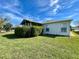 Spacious backyard features a privacy hedge and well-kept lawn, creating a serene outdoor environment at 16304 Sw 12Th Ter, Ocala, FL 34473