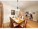 Traditional dining room is complete with wood floors, chandelier, and a charming wood dining set at 16304 Sw 12Th Ter, Ocala, FL 34473