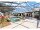 Gorgeous screened-in pool with ample patio space and outdoor lounge area at 2023 Se Laurel Run Dr, Ocala, FL 34471