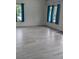 Bright living room featuring modern floors and bright windows with blue drapes at 26 Hemlock Cir, Ocala, FL 34472