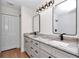 Bright bathroom features a double vanity with granite countertops, modern lighting, and sleek black fixtures at 3496 Sw 149Th Ct, Ocala, FL 34481