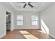 Bright bedroom with wood flooring, ceiling fan and en-suite bathroom at 3496 Sw 149Th Ct, Ocala, FL 34481