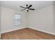 Bedroom with wood floors and a modern fan, showcasing natural light from a window at 3496 Sw 149Th Ct, Ocala, FL 34481