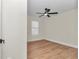 Minimal bedroom with wood floors, neutral paint, a window, and a modern ceiling fan at 3496 Sw 149Th Ct, Ocala, FL 34481