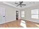 Bright bedroom with wood flooring, ceiling fan and en-suite bathroom at 3496 Sw 149Th Ct, Ocala, FL 34481