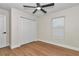 Spacious bedroom with ceiling fan, double door closet, and light flooring at 3496 Sw 149Th Ct, Ocala, FL 34481