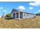 Side view of a new gray house with white trim and landscaping at 3496 Sw 149Th Ct, Ocala, FL 34481