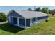 Exterior side view of single Gathering home featuring a covered patio with two support beams at 3496 Sw 149Th Ct, Ocala, FL 34481