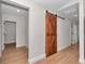 Hallway with barn door and light wood flooring at 3496 Sw 149Th Ct, Ocala, FL 34481