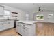 Modern kitchen island with granite countertop and gray cabinets at 3496 Sw 149Th Ct, Ocala, FL 34481