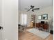 Cozy office space with wood floors, neutral walls, decorative shelving, and large window at 3496 Sw 149Th Ct, Ocala, FL 34481