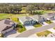 Aerial view of a modern home with a three-car garage nestled on a golf course community at 4522 Shockoe Cir, The Villages, FL 32163