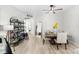 Cozy dining area featuring a rustic table, decorative shelving, and ample natural light at 4522 Shockoe Cir, The Villages, FL 32163