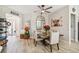 Dining room with a wood table, upholstered chairs, ceiling fan, and stylish decor at 4522 Shockoe Cir, The Villages, FL 32163