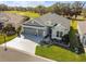 Aerial view of a single-Gathering home featuring a three-car garage, well-manicured lawn, and landscaped flower beds at 4522 Shockoe Cir, The Villages, FL 32163