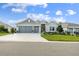 Charming home featuring a well-manicured lawn, a two-car garage and decorative holiday lighting at 4522 Shockoe Cir, The Villages, FL 32163