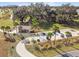 Overhead view of a golf cart parking area with a nearby structure and surrounding trees at 4522 Shockoe Cir, The Villages, FL 32163