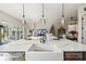 Kitchen island featuring stone countertops, modern faucet and sink, and decorative lighting at 4522 Shockoe Cir, The Villages, FL 32163