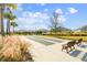 View of well-maintained shuffleboard courts with benches, mature trees and landscaping in a residential community at 4522 Shockoe Cir, The Villages, FL 32163